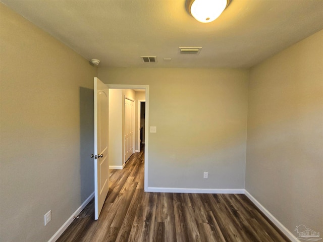 spare room featuring dark hardwood / wood-style flooring