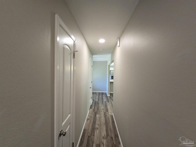 corridor with wood-type flooring