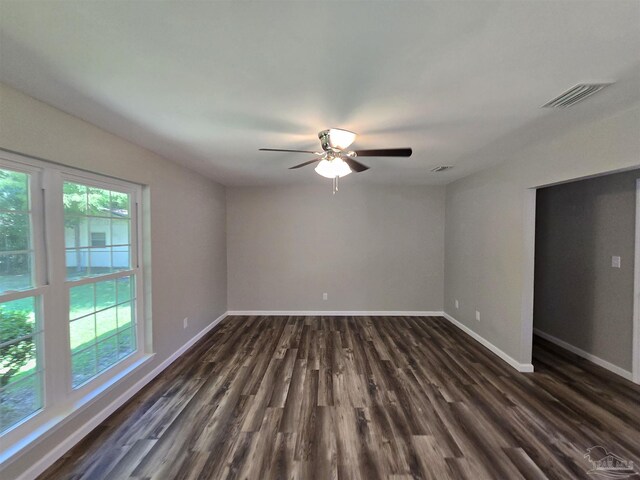 kitchen with stainless steel appliances, pendant lighting, decorative backsplash, white cabinetry, and dark wood-type flooring