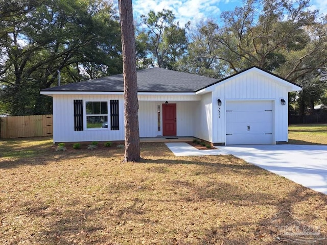 ranch-style home featuring a garage, driveway, fence, and a front yard