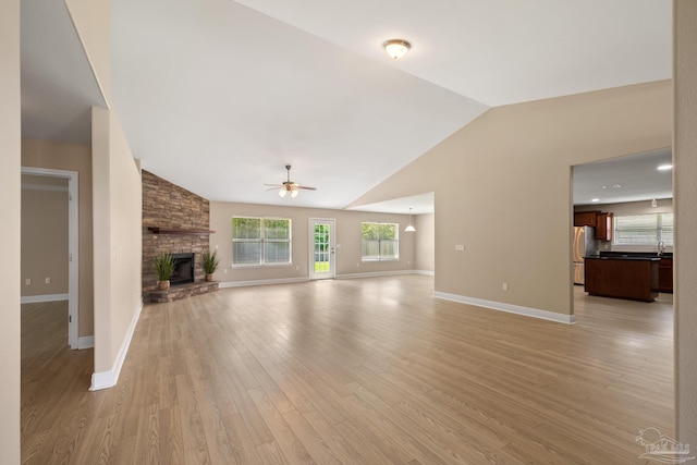 1804 Twin Pine Blvd, Gulf Breeze, FL 32563 - unfurnished living room with a ceiling fan, lofted ceiling, a fireplace, and light wood finished floors