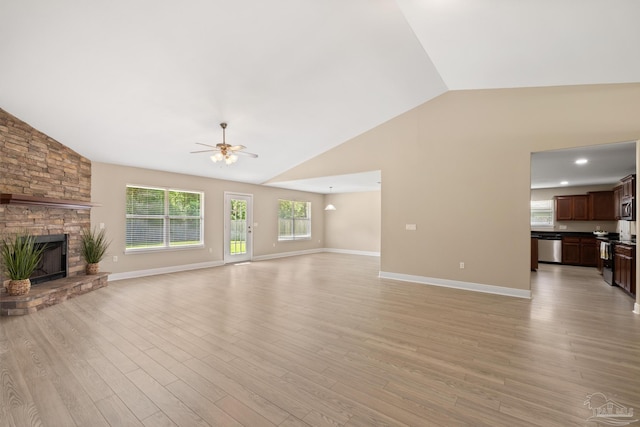 1804 Twin Pine Blvd, Gulf Breeze, FL 32563 - unfurnished living room with vaulted ceiling, a ceiling fan, a fireplace, and light wood-type flooring