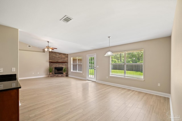 1804 Twin Pine Blvd, Gulf Breeze, FL 32563 - unfurnished living room with ceiling fan, a stone fireplace, light wood finished floors, and lofted ceiling
