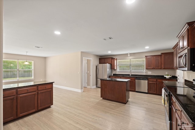 1804 Twin Pine Blvd, Gulf Breeze, FL 32563 - kitchen featuring stainless steel appliances, dark countertops, a kitchen island, recessed lighting, and light wood-style floors