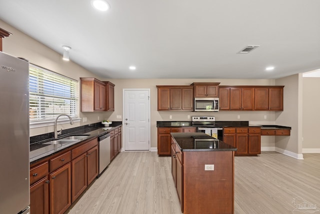 1804 Twin Pine Blvd, Gulf Breeze, FL 32563 - kitchen featuring appliances with stainless steel finishes, light wood-style flooring, recessed lighting, a kitchen island, and dark stone countertops