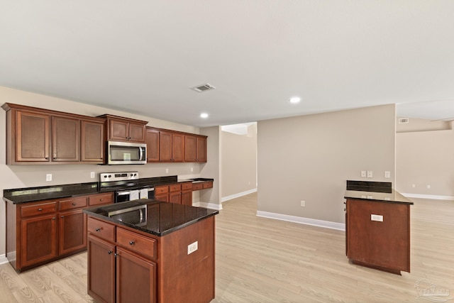 1804 Twin Pine Blvd, Gulf Breeze, FL 32563 - kitchen with stainless steel appliances, light wood-style flooring, a center island, dark stone countertops, and recessed lighting