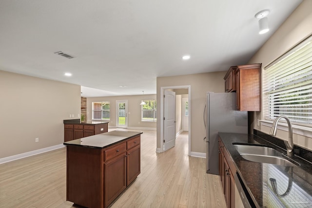 1804 Twin Pine Blvd, Gulf Breeze, FL 32563 - kitchen with stainless steel appliances, light wood-style floors, a center island, dark stone countertops, and recessed lighting