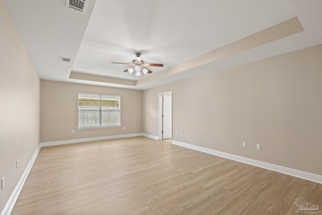 1804 Twin Pine Blvd, Gulf Breeze, FL 32563 - empty room with a raised ceiling, light wood-style flooring, and a ceiling fan