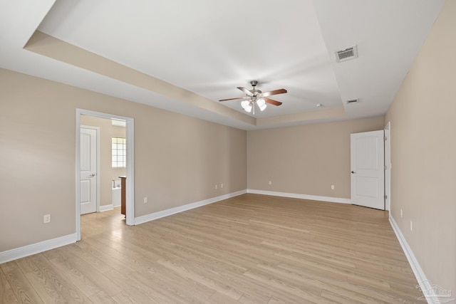 1804 Twin Pine Blvd, Gulf Breeze, FL 32563 - spare room featuring a tray ceiling, a ceiling fan, and light wood-style flooring