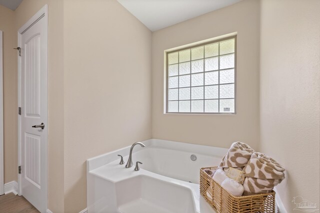 1804 Twin Pine Blvd, Gulf Breeze, FL 32563 - bathroom featuring a garden tub and baseboards