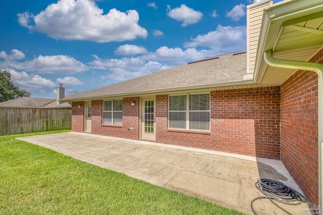 1804 Twin Pine Blvd, Gulf Breeze, FL 32563 - rear view of house with brick siding, a patio, roof with shingles, and a chimney