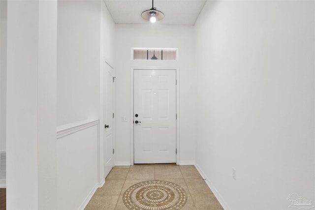 doorway with light tile patterned floors