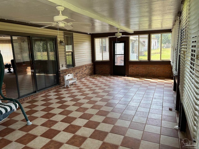 unfurnished sunroom with ceiling fan and plenty of natural light