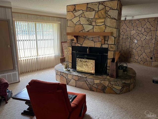 carpeted living room with a fireplace and a textured ceiling