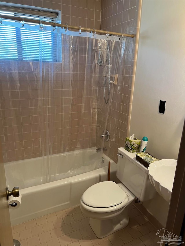 bathroom featuring tile patterned floors, shower / tub combo with curtain, and toilet