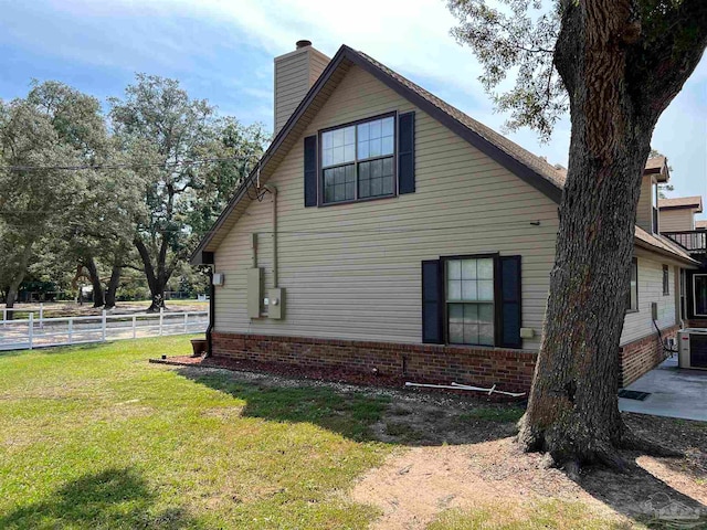 view of side of property with a yard