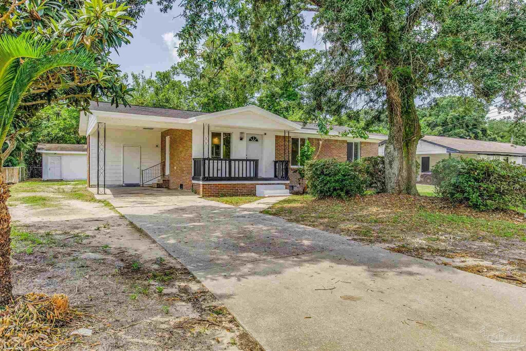 single story home with a carport and covered porch