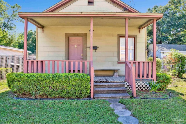 bungalow featuring a porch and a front lawn