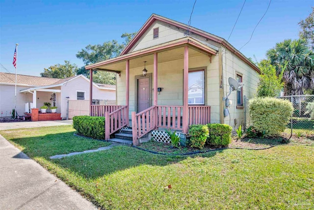 bungalow with a porch and a front yard