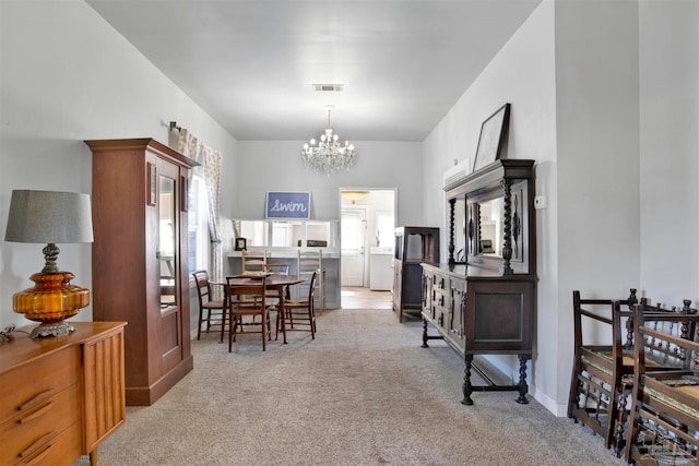 carpeted dining room featuring a healthy amount of sunlight and a chandelier