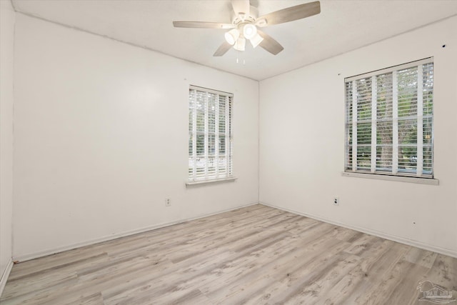 empty room featuring ceiling fan and light hardwood / wood-style floors