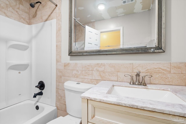 full bathroom featuring vanity, toilet, and tiled shower / bath