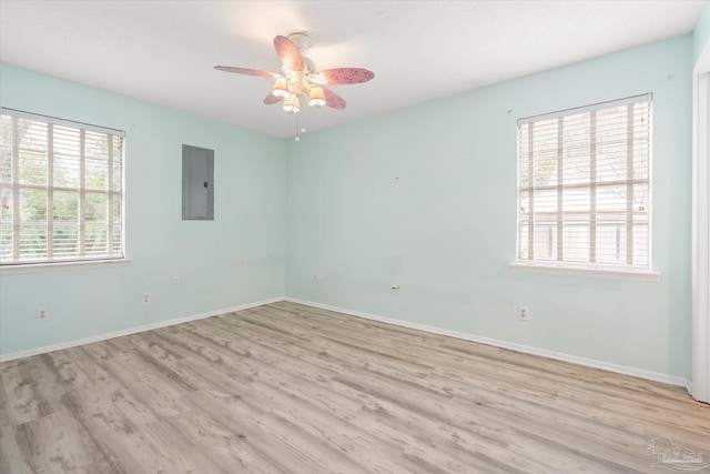 unfurnished room with light wood-type flooring and a wealth of natural light