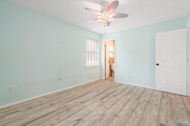 empty room with ceiling fan and light hardwood / wood-style floors