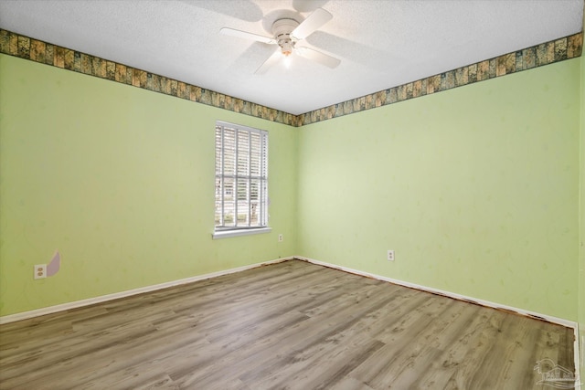 spare room with a textured ceiling, hardwood / wood-style flooring, and ceiling fan