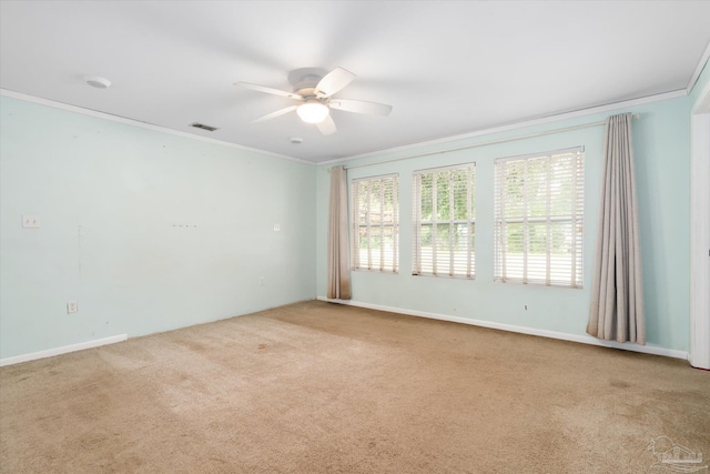 carpeted empty room with ceiling fan and ornamental molding