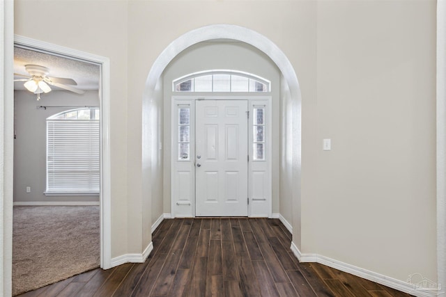 entryway with dark wood-type flooring and ceiling fan