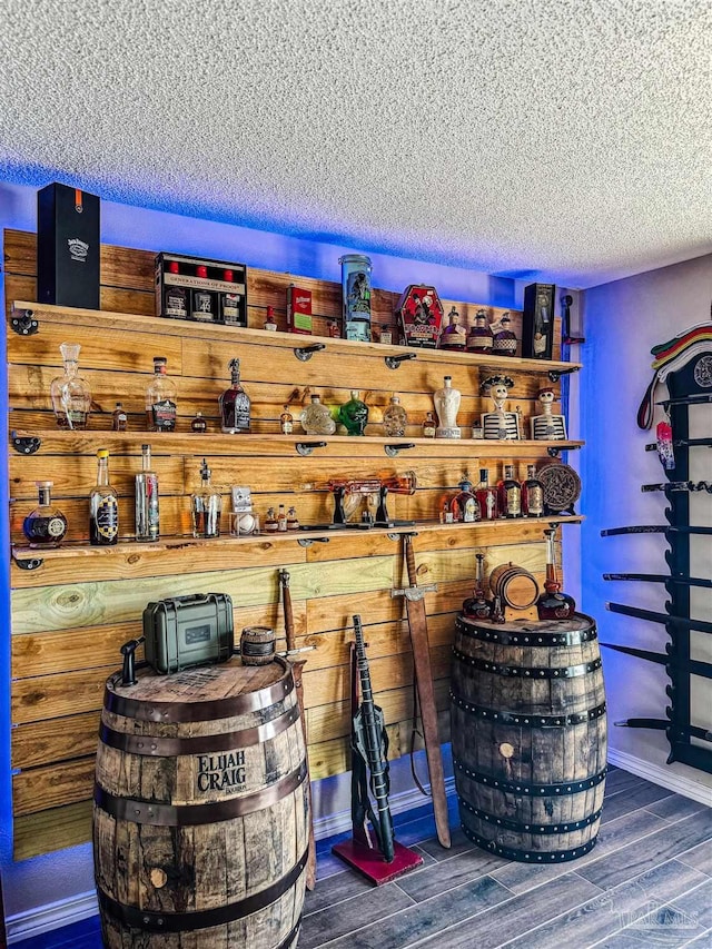 storage room with dark hardwood / wood-style flooring and a textured ceiling