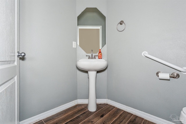 bathroom with wood-type flooring and toilet