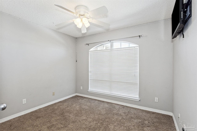 carpeted empty room with ceiling fan and a textured ceiling