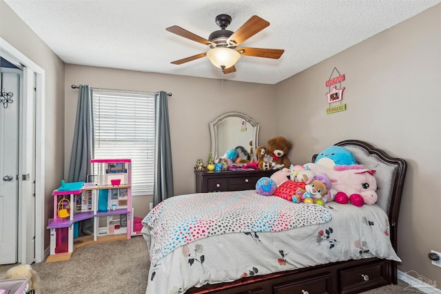 bedroom featuring ceiling fan, carpet floors, and a textured ceiling