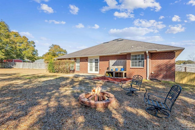 back of house featuring french doors and an outdoor fire pit