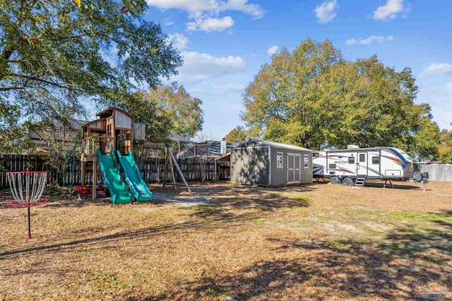 view of jungle gym with a storage shed and a yard