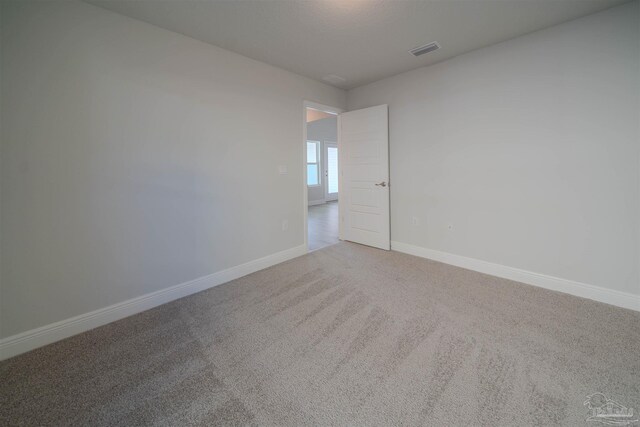 home office with light wood-style floors, baseboards, visible vents, and a textured ceiling