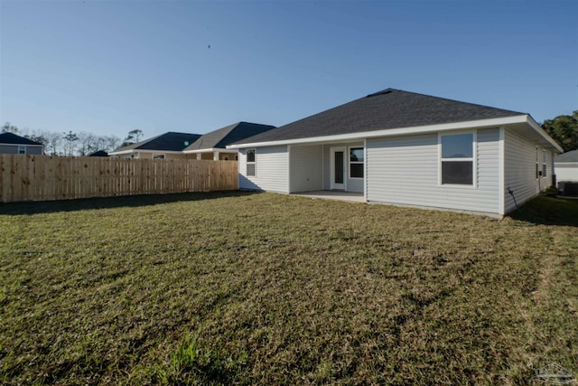 back of house with a yard, central AC, a patio area, and fence