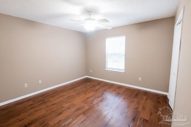 spare room with ceiling fan, wood-type flooring, and a textured ceiling