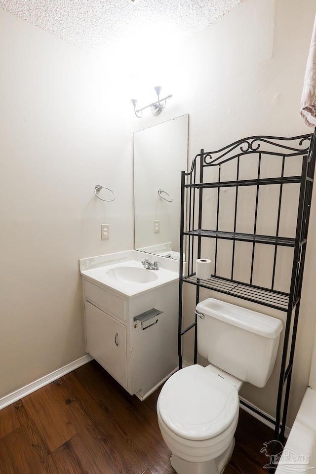 bathroom featuring hardwood / wood-style floors, vanity, and toilet