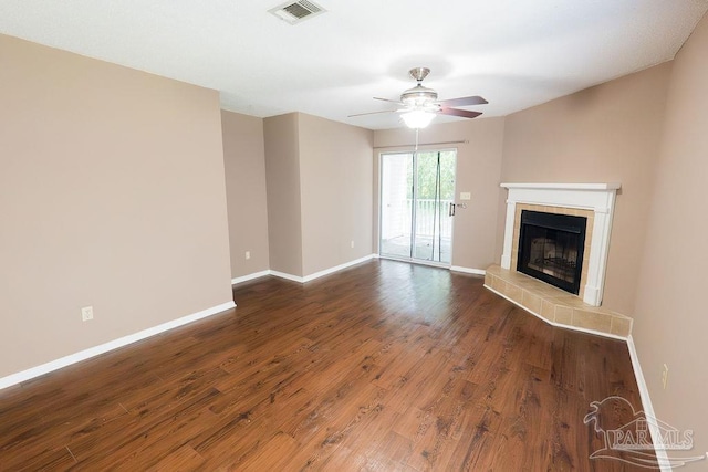 unfurnished living room featuring hardwood / wood-style flooring, ceiling fan, and a fireplace