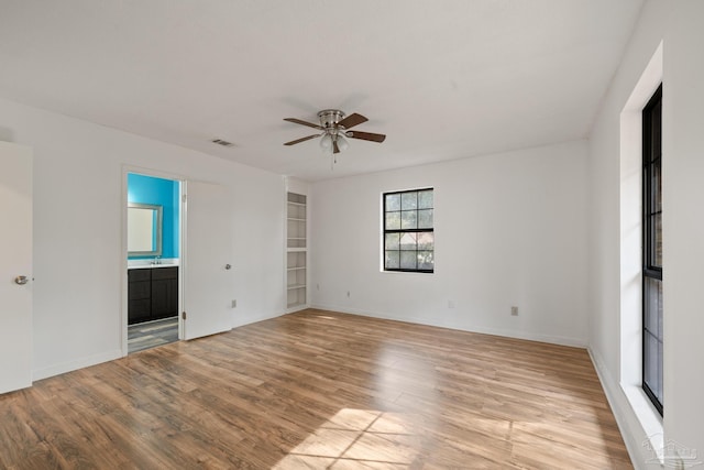 spare room featuring light hardwood / wood-style flooring and ceiling fan