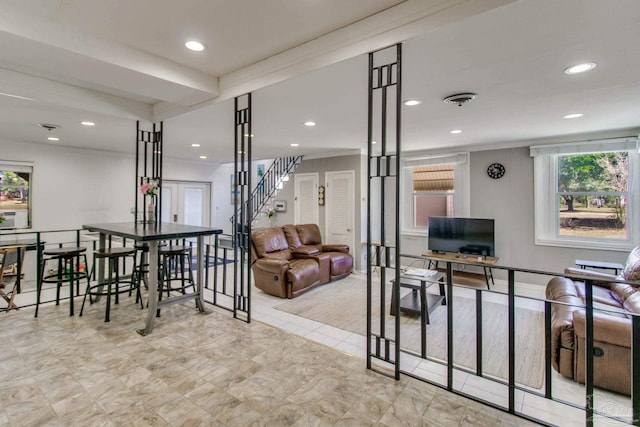 living room featuring stairs, visible vents, and recessed lighting