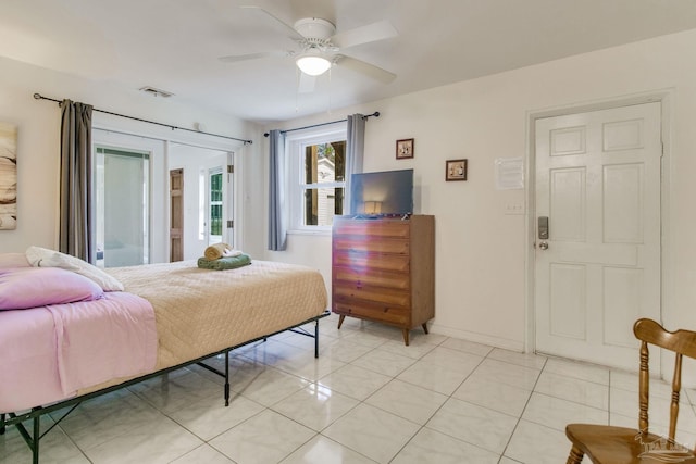 bedroom with light tile patterned floors, ceiling fan, visible vents, baseboards, and access to exterior