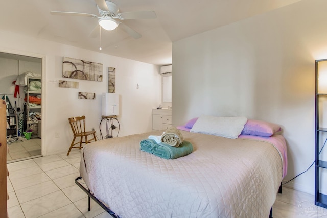 bedroom with a closet, an AC wall unit, light tile patterned flooring, and ceiling fan