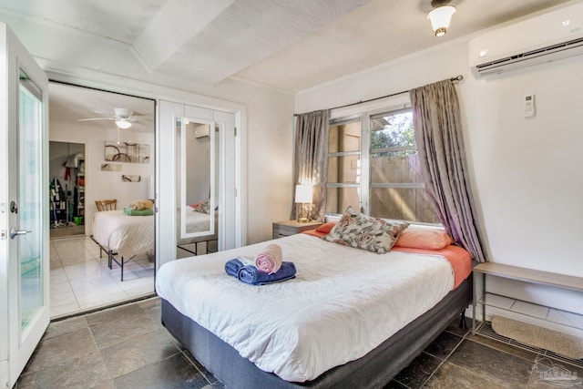 bedroom featuring a closet, a wall mounted air conditioner, stone finish flooring, and french doors