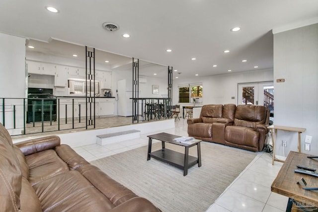 living area featuring recessed lighting, visible vents, crown molding, and light tile patterned floors