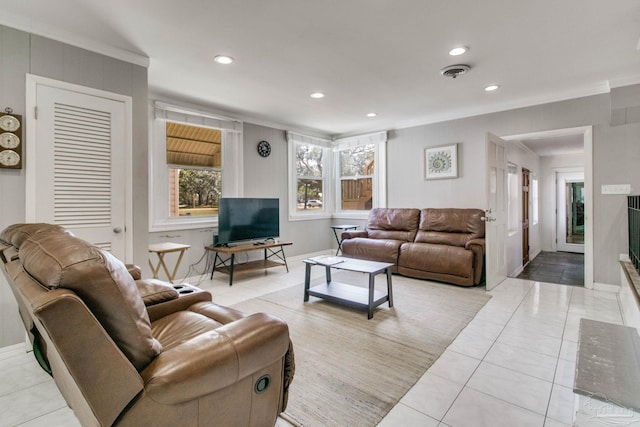 tiled living area with baseboards, visible vents, crown molding, and recessed lighting