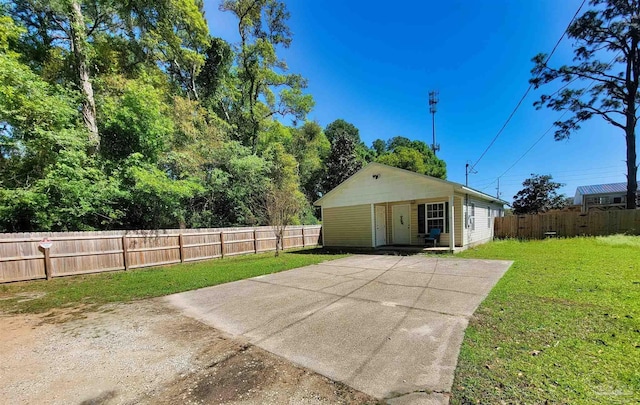 back of property with fence private yard and a lawn